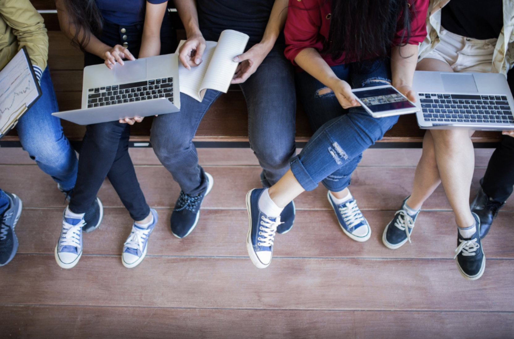 Students studying together with laptops and notebooks