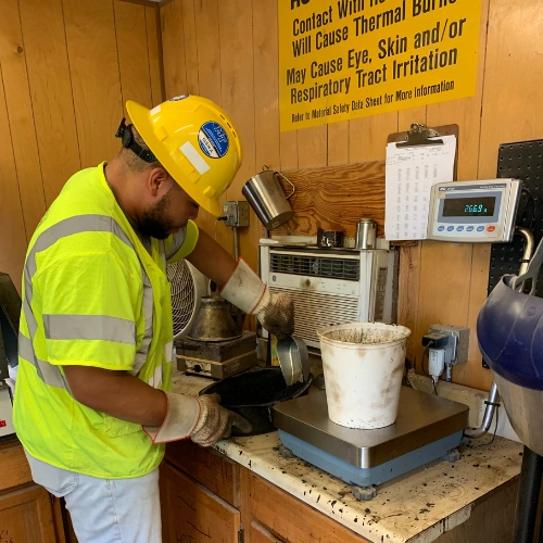 Harrison intern Brandon Lurry running a quality test at an asphalt and concrete lab bench