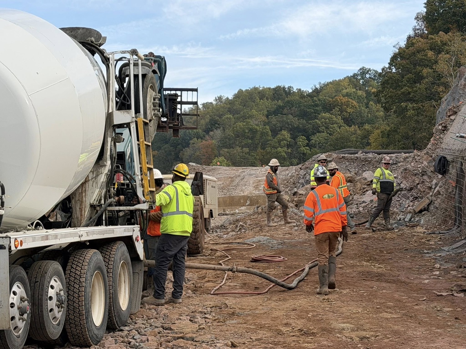 Harrison crew and a ready-mix concrete truck working at a quarry and rock excavation site