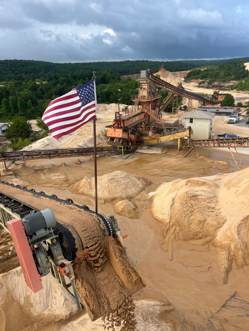 An American flag flying over a MidSouth Aggregates sand and gravel processing plant