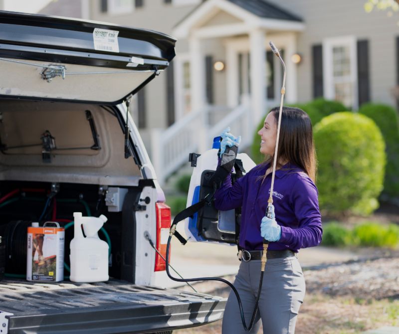 MissQuito technician loading eco-friendly equipment from a service vehicle
