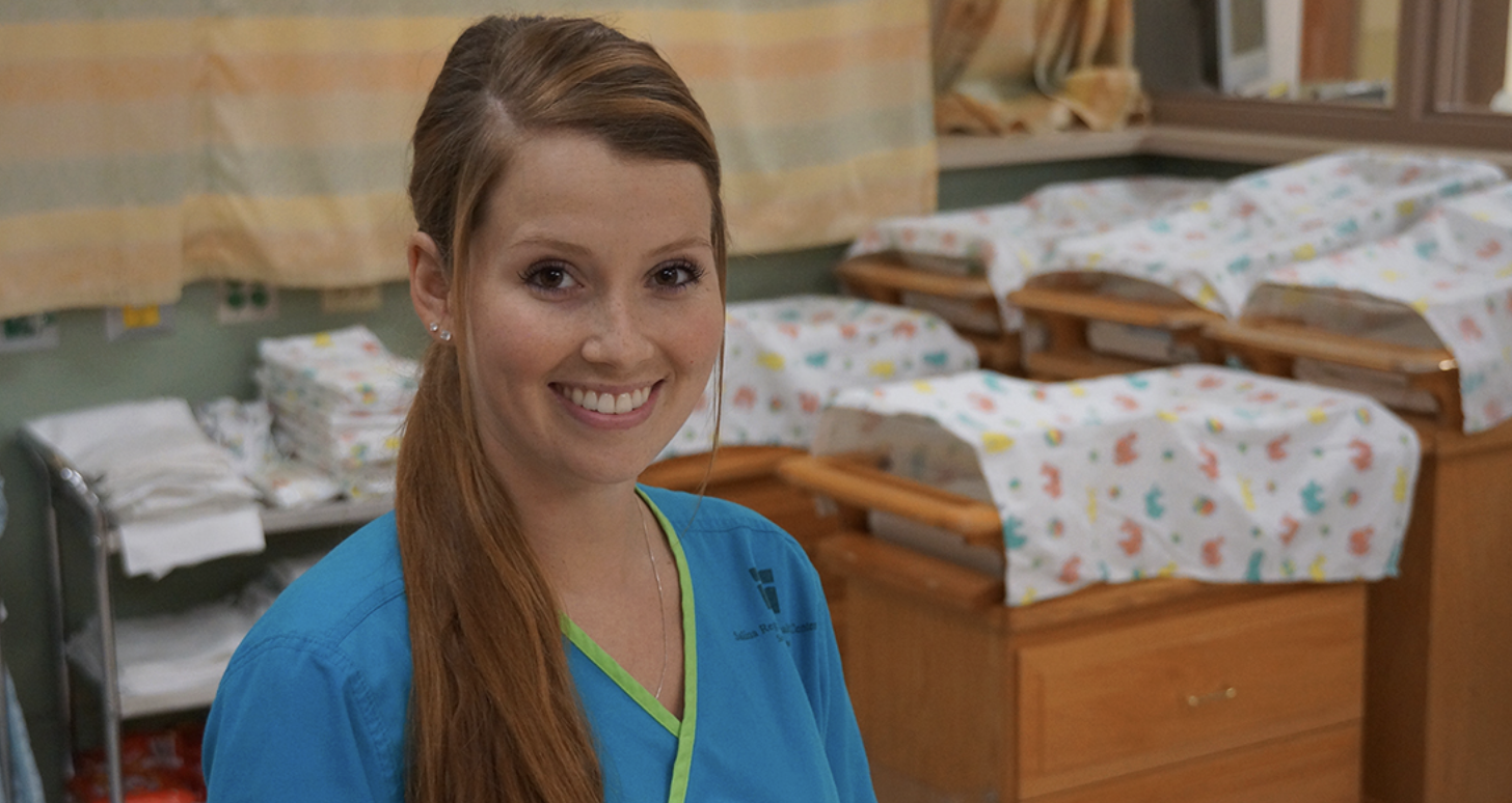 A smiling Salina Regional Health Center nurse in the hospital's newborn nursery