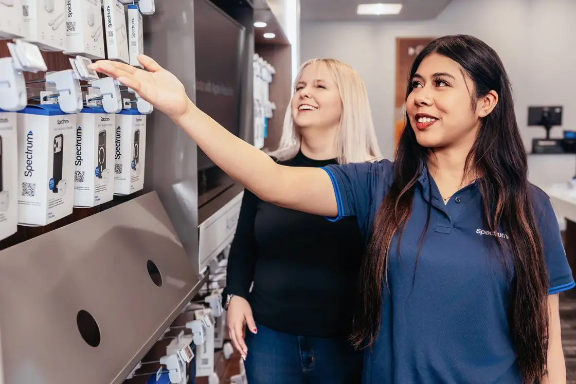Spectrum Retail employees helping customers in a Spectrum store